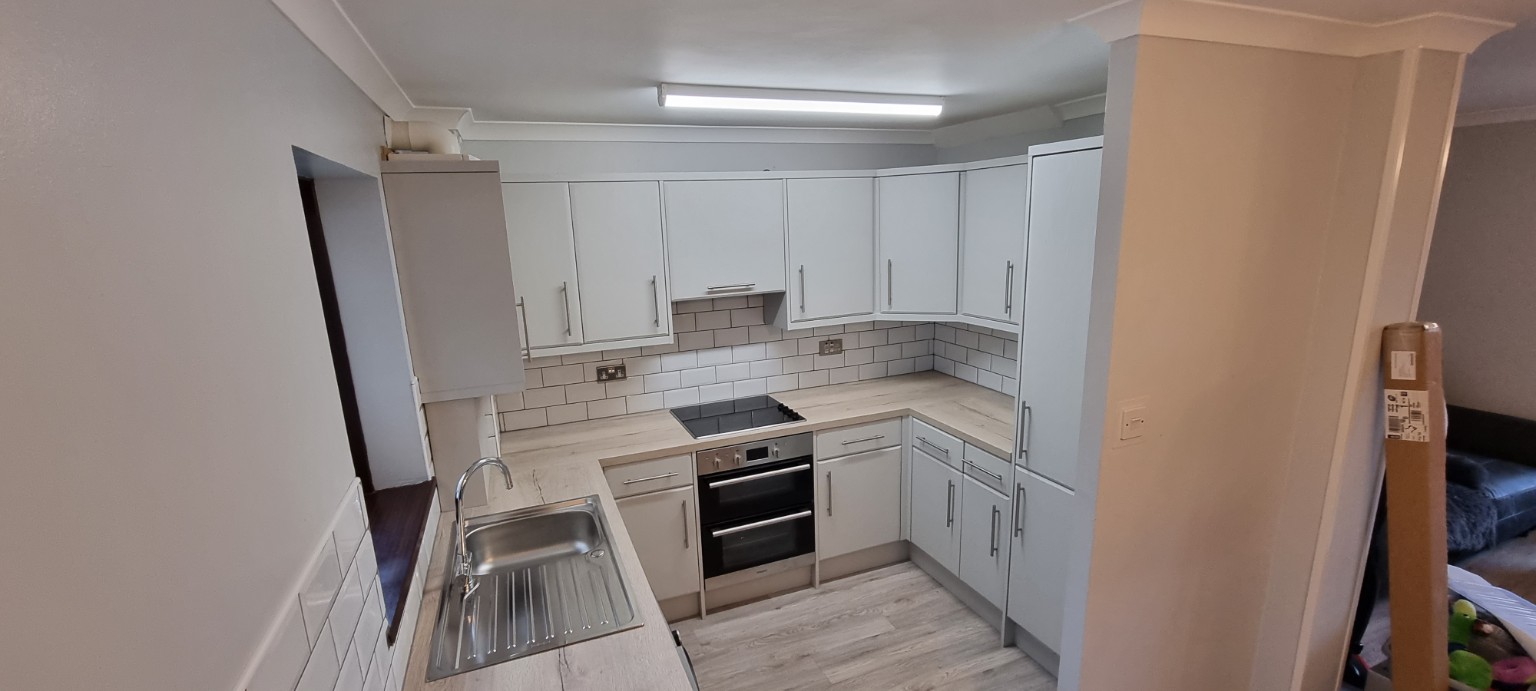 Completed U-shaped kitchen seen from the doorway